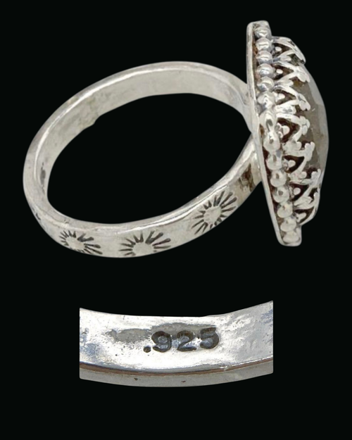 Side view of a sterling silver ring with stamped sunbursts on the band and a beaded crown bezel, with the .925 mark, IM-0057