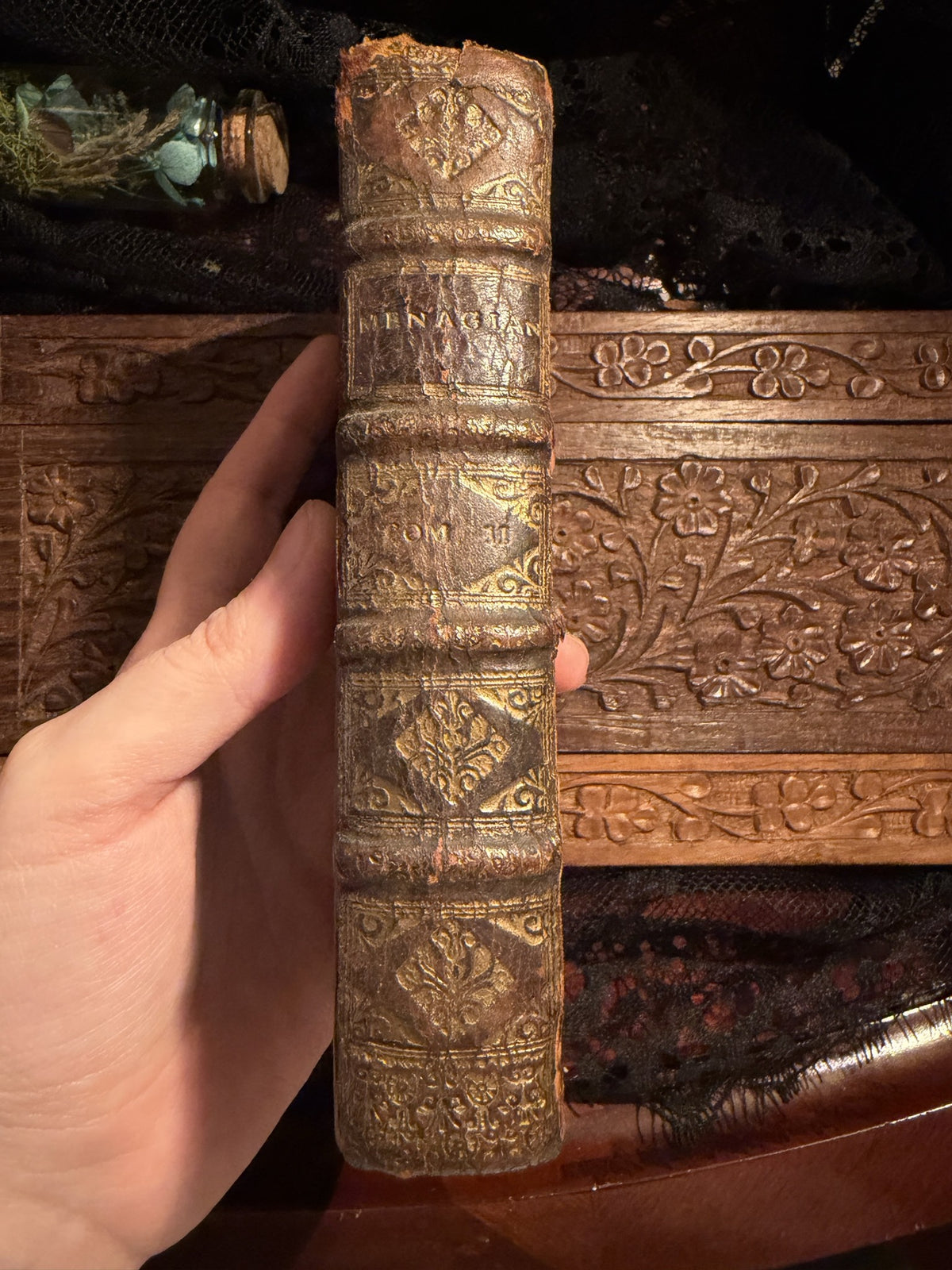 Spine of Menagiana Tome II, worn calf with gilt floral tooling between raised bands, IM-0051