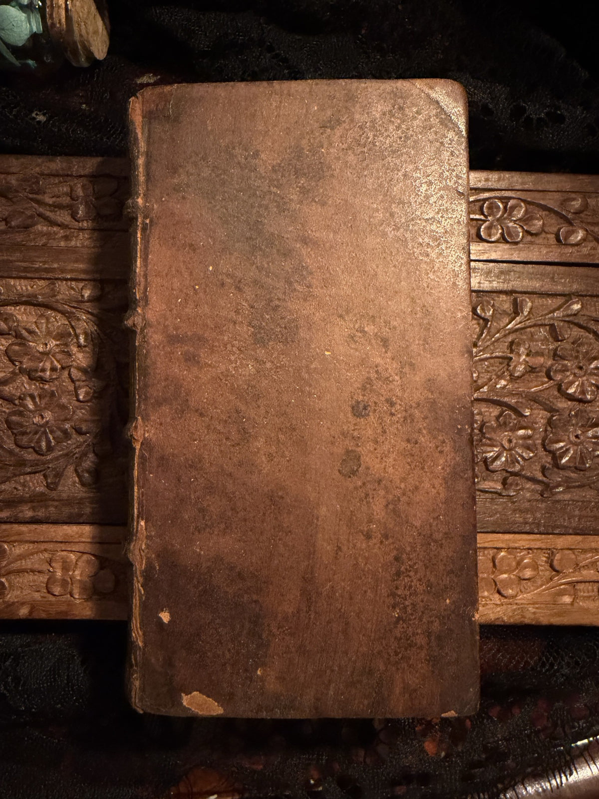 Plain worn calf front board of Menagiana Tome II on a carved wood panel, IM-0051