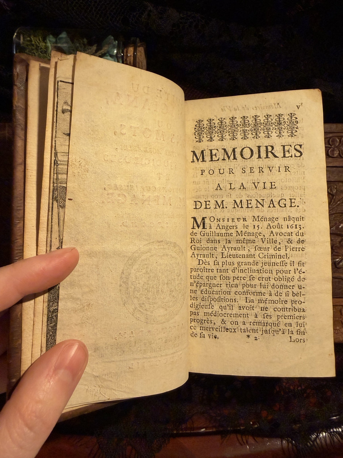 Opening of the Memoires on the life of M. Menage, the book held open in one hand, IM-0051