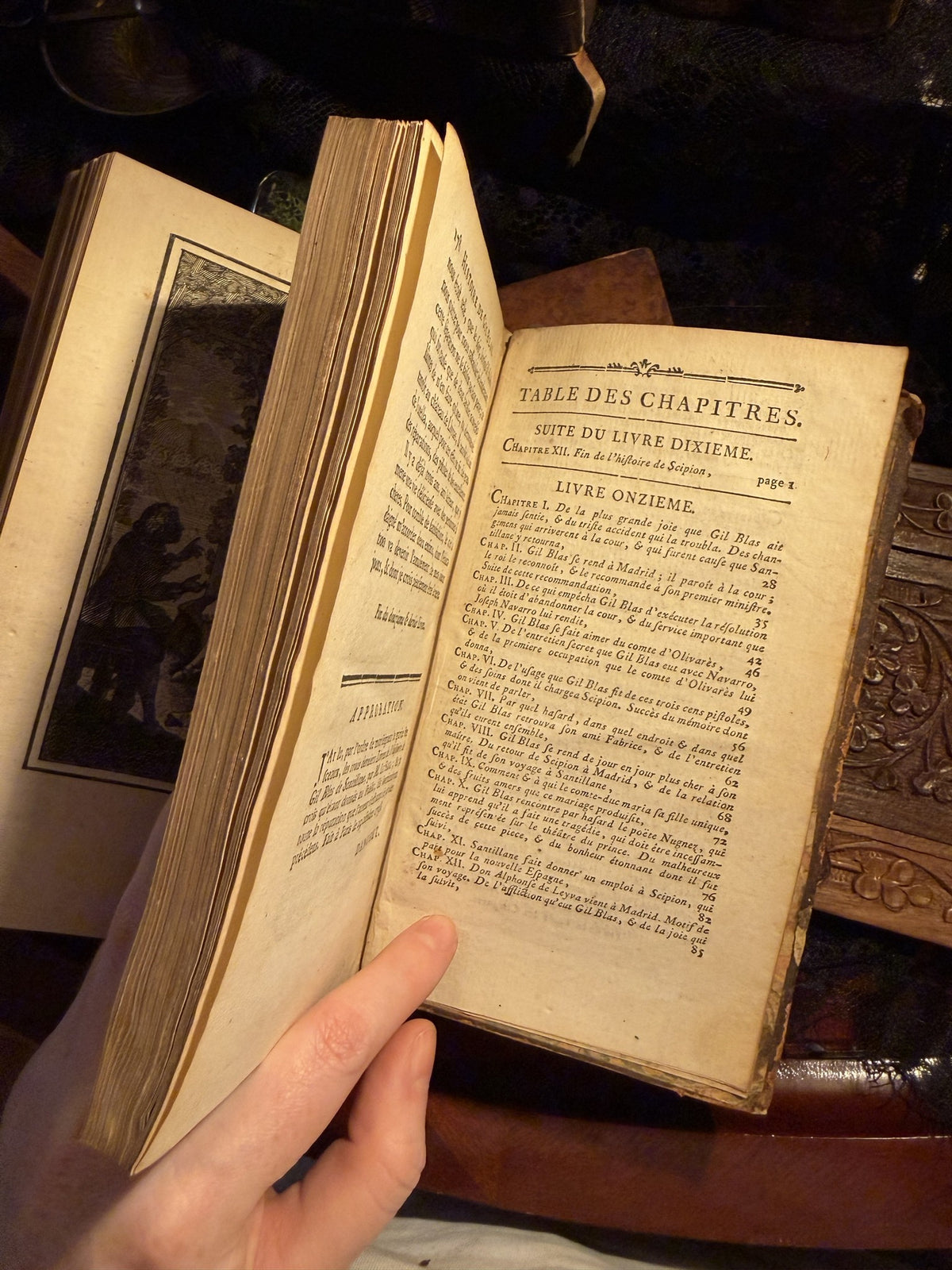 Table des Chapitres of Gil Blas Tome V, the book fanned open with a plate behind, IM-0054