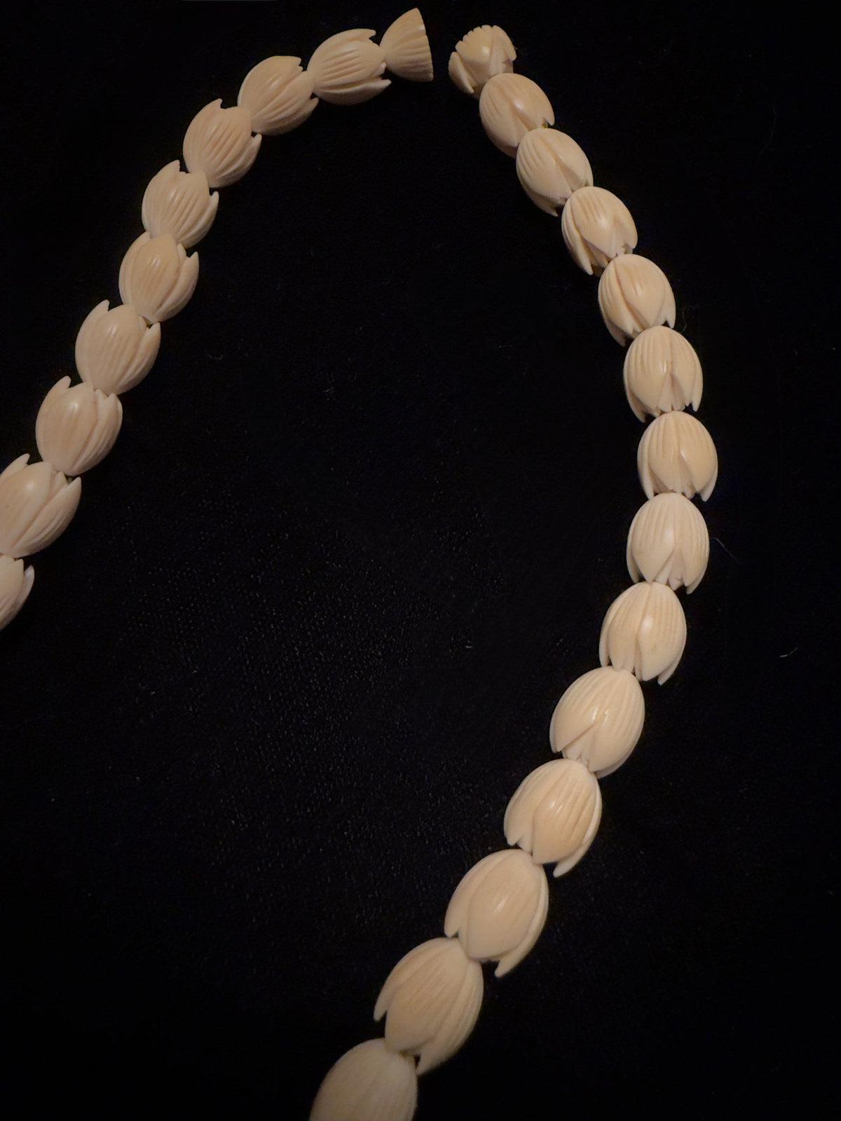 Carved bone flower bud beads, close view of the strand, IM-0142